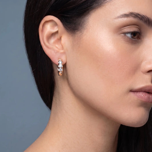14KT Rose Gold Diamond Huggie Hoop Earrings - worn close up