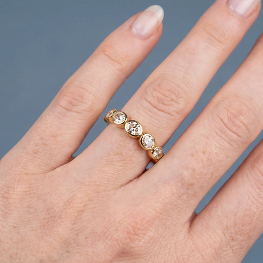 10K Yellow Gold Seven Stone Oval Cut Bezel Set Diamond Half Eternity Wedding Band - worn on hand