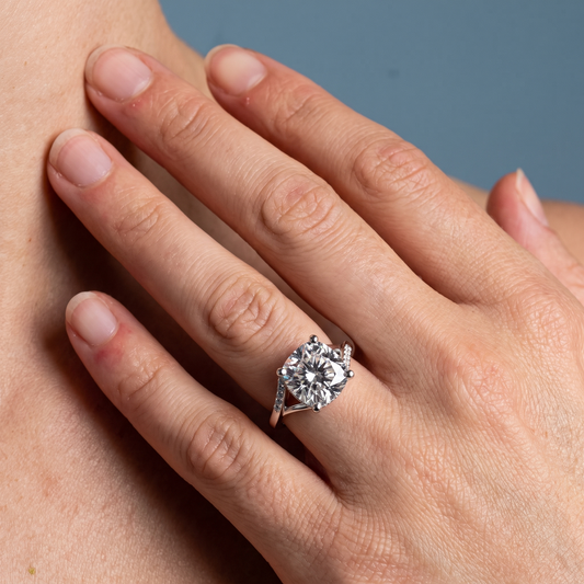 18 KT White Gold Cushion Cut Diamond Split Shank Engagement Ring with Hidden Halo - worn close-up