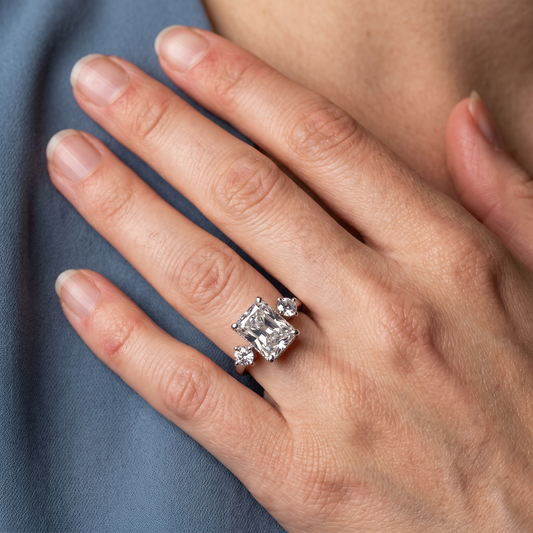 Platinum Radiant Cut Diamond Three Stone Engagement Ring with Hidden Halo - worn close-up