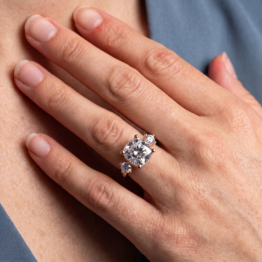 18 KT Rose Gold Cushion Cut Diamond Three Stone Engagement Ring with Hidden Halo - worn close-up