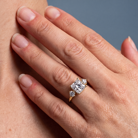14 KT Yellow Gold Princess Cut Diamond Three Stone Engagement Ring with Hidden Halo - worn close-up