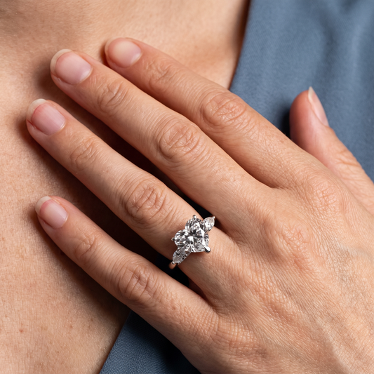 18 KT White Gold Heart Cut Diamond Cluster Engagement Ring with Pear Accents - worn close-up