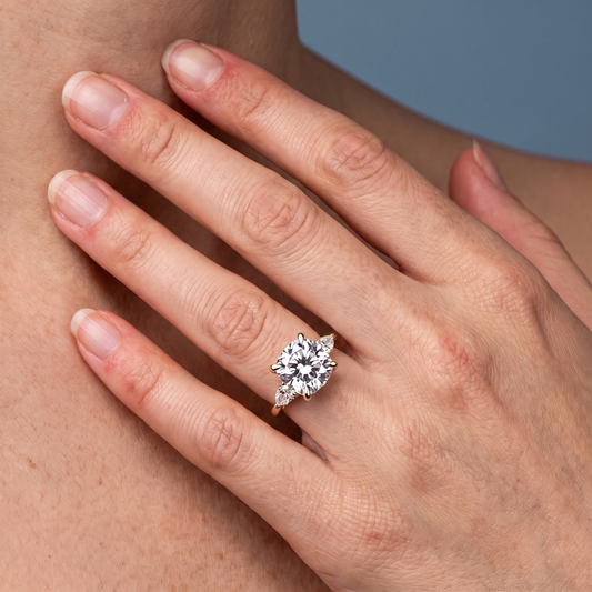14 KT Yellow Gold Cushion Cut Diamond Cluster Engagement Ring with Pear Accents - worn close-up