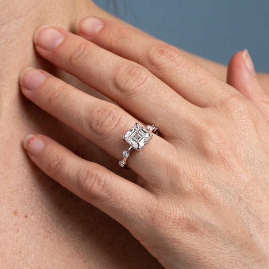 Platinum Asscher Cut Diamond Solitaire Ring with Floating Diamond Accents - worn close-up