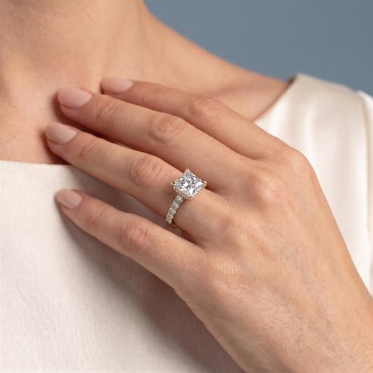 14 KT Yellow Gold Princess Cut Diamond Solitaire Ring with Pave Eternity Band - worn close-up