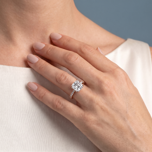 18 KT Rose Gold Asscher Cut Diamond Solitaire Ring with Hidden Halo and French Pave Band - worn close-up