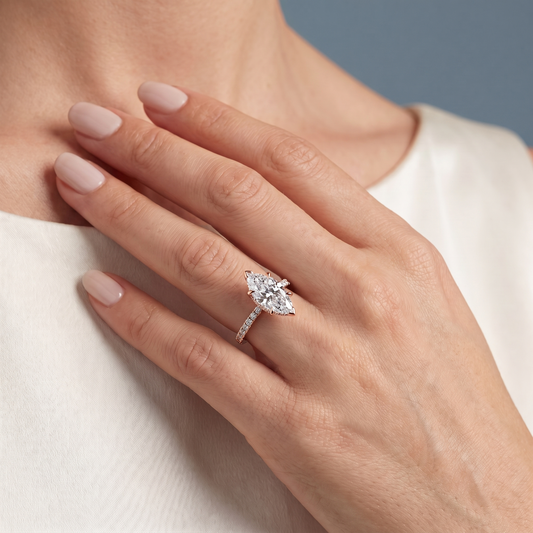 18 KT Rose Gold Marquise Cut Diamond Solitaire Ring with Hidden Halo and French Pave Band - worn close-up
