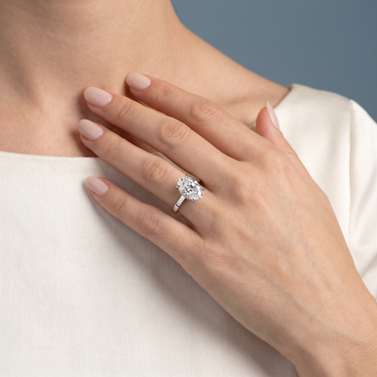 Platinum Oval Cut Diamond Solitaire Ring with Cathedral Band - worn close-up
