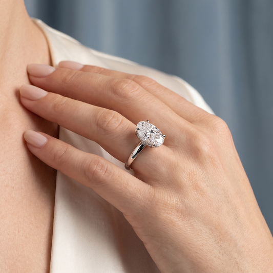 18 KT White Gold Oval Cut Diamond Hidden Halo Solitaire Ring - worn close-up