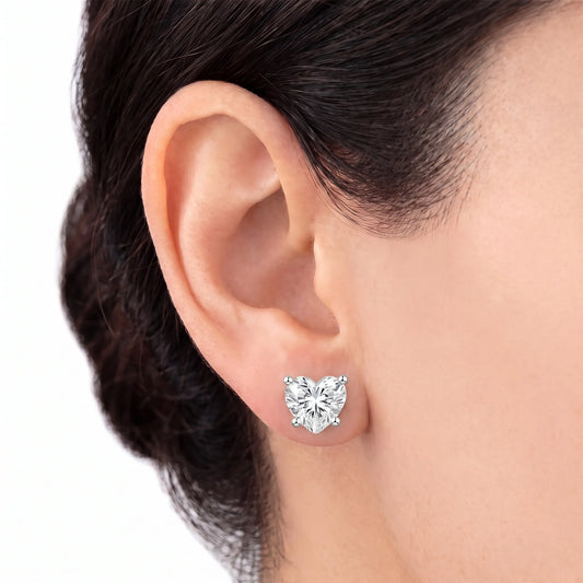 Heart cut diamond stud earring in white gold worn on ear