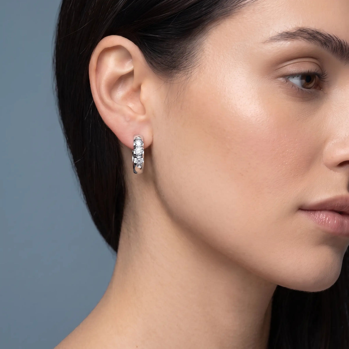 10KT White Gold Diamond Huggie Hoop Earrings - worn close up