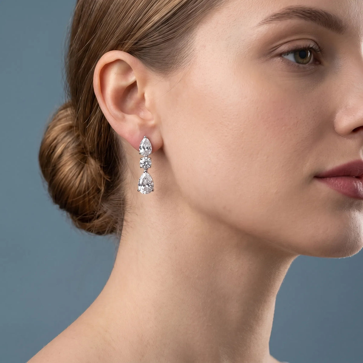 Silver Diamond Pear Round Three Stone Earrings - worn close up