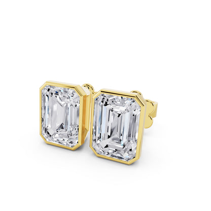 Bezel emerald cut diamond stud earrings yellow gold close up view