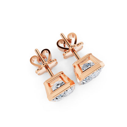 Bezel emerald cut diamond stud earrings rose gold top view