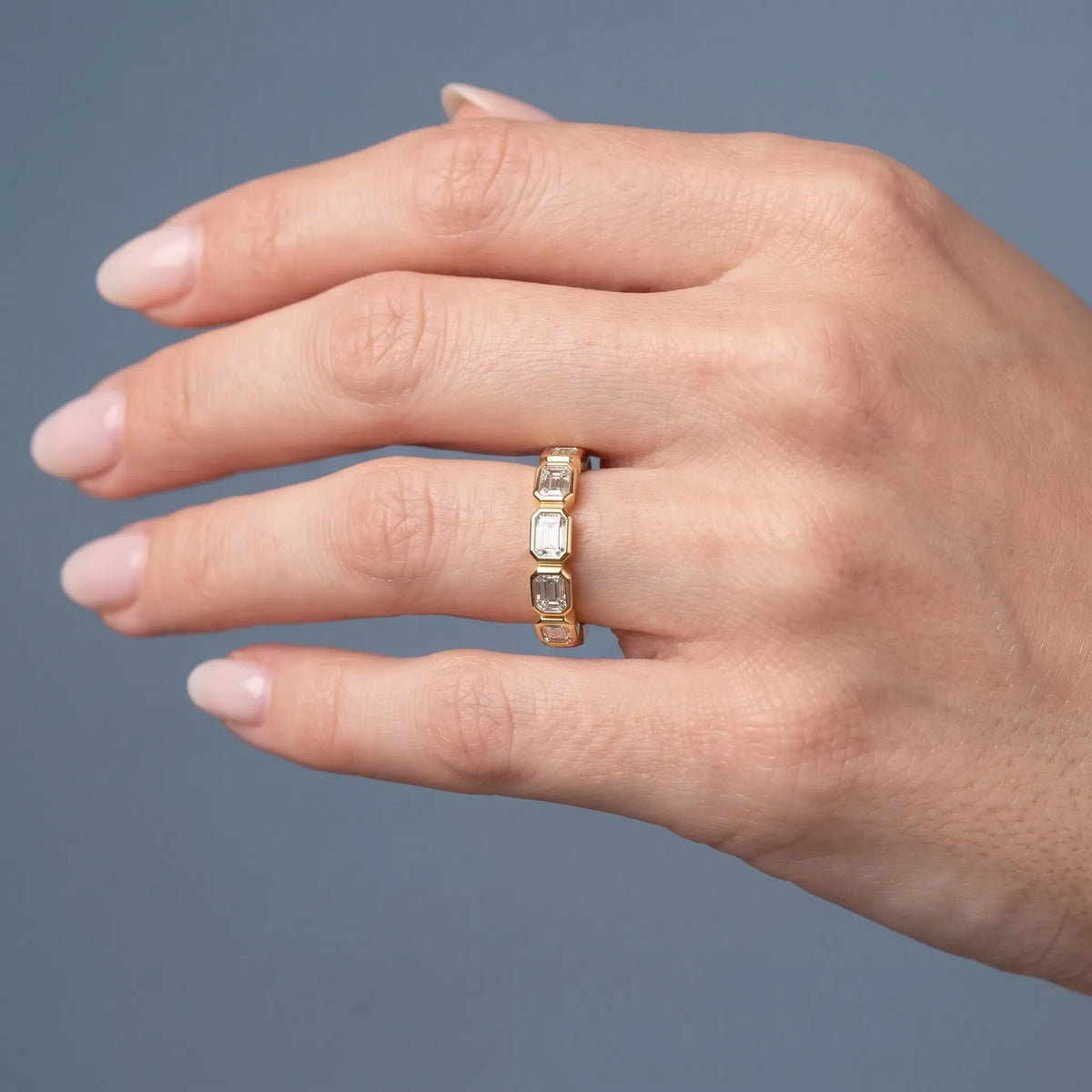 10K Yellow Gold Seven Stone Emerald Cut Bezel Set Diamond Half Eternity Wedding Band - worn on hand
