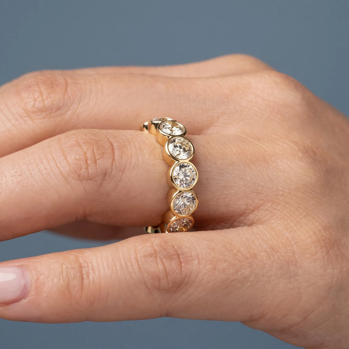 14K Yellow Gold Round Cut Bezel Set Diamond Full Eternity Wedding Band 4.1mm - worn on hand