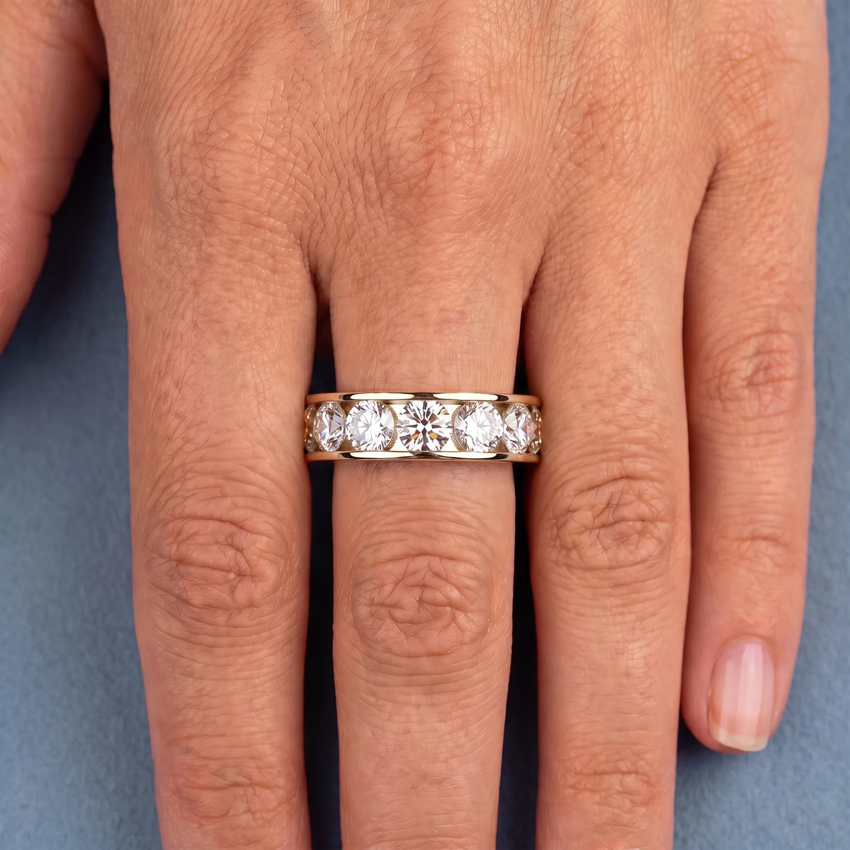 10K Yellow Gold Round Cut Diamond Channel Set Eternity Band 4.2mm - worn on hand