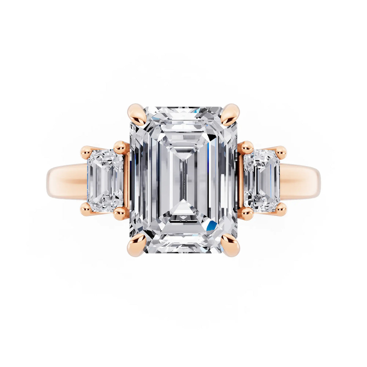 18 KT Rose Gold Emerald Cut Diamond Three Stone Emerald Accent Ring - top angle