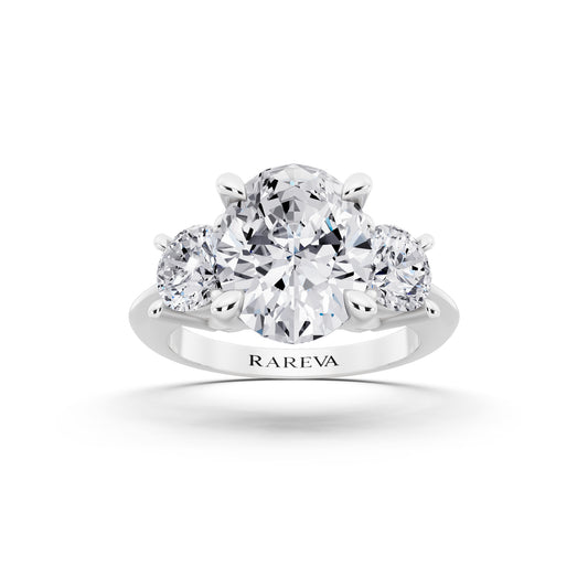 Platinum Oval Cut Diamond Three Stone Ring with Round Accents - front view