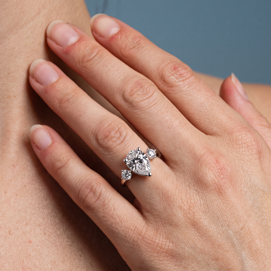 18 KT White Gold Pear Cut Diamond Three Stone Engagement Ring with Hidden Halo - worn close-up