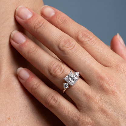 18 KT White Gold Princess Cut Diamond Three Stone Engagement Ring with Hidden Halo - worn close-up
