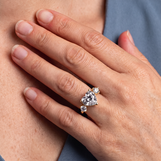 18 KT Yellow Gold Heart Cut Diamond Three Stone Engagement Ring with Hidden Halo - worn close-up