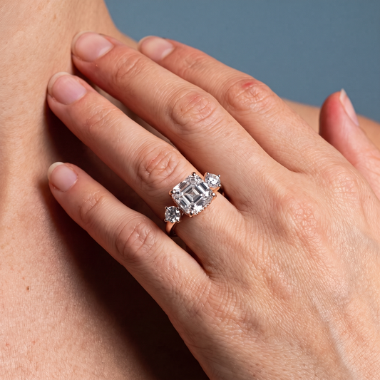 18 KT Rose Gold Asscher Cut Diamond Three Stone Engagement Ring with Hidden Halo - worn close-up