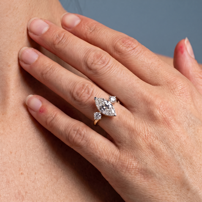 18 KT Yellow Gold Marquise Cut Diamond Three Stone Engagement Ring with Hidden Halo - worn close-up