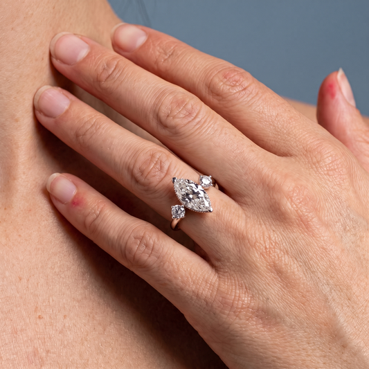 18 KT Rose Gold Marquise Cut Diamond Three Stone Engagement Ring with Hidden Halo - worn close-up