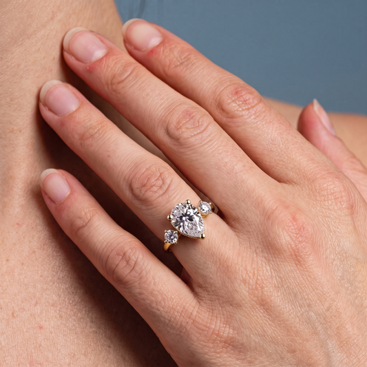 14 KT Yellow Gold Pear Cut Diamond Three Stone Engagement Ring with Hidden Halo - worn close-up