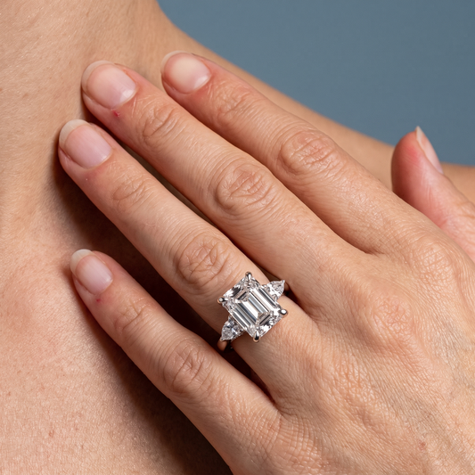 Platinum Emerald Cut Diamond Cluster Engagement Ring with Pear Accents - worn close-up