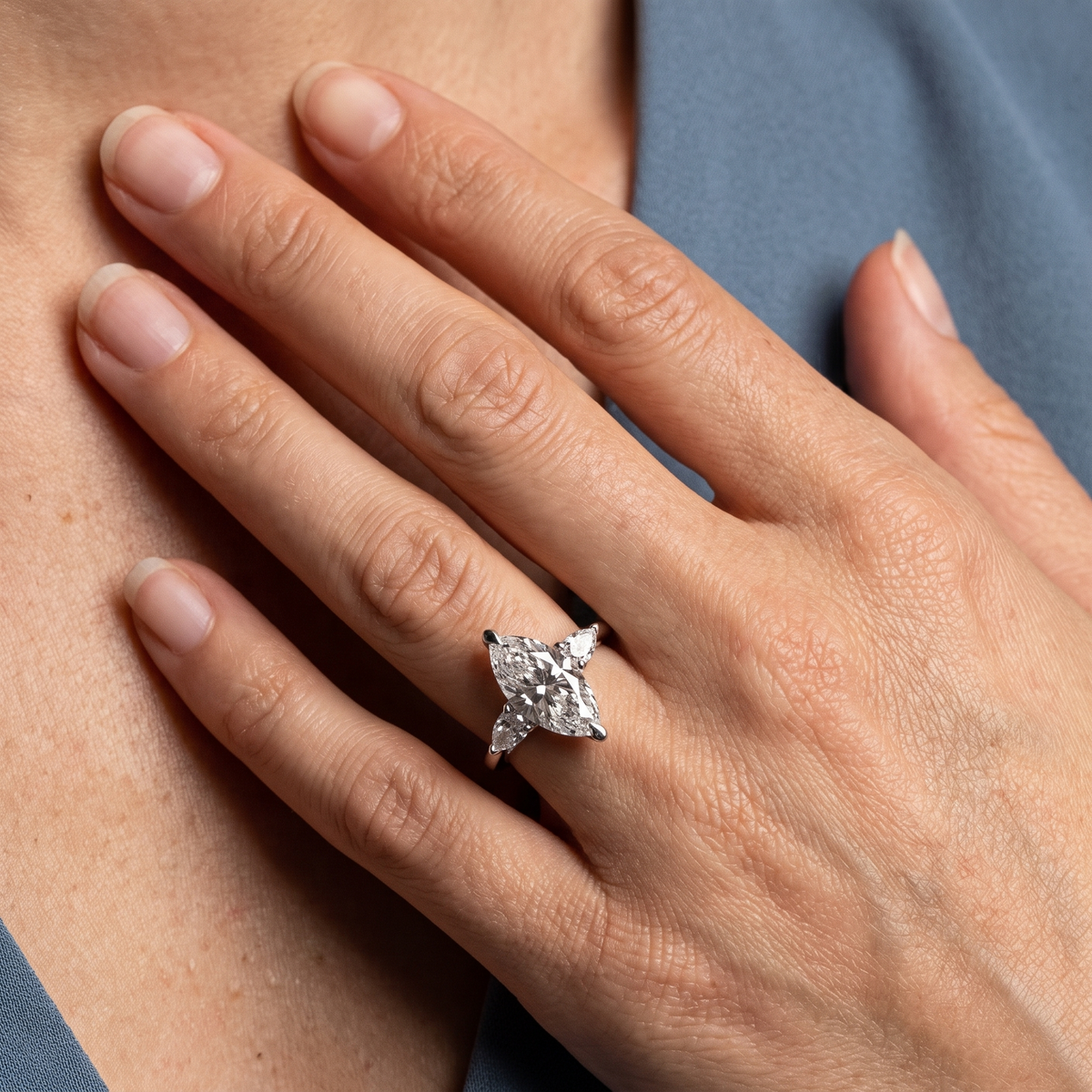 14 KT White Gold Marquise Cut Diamond Cluster Engagement Ring with Pear Accents - worn close-up
