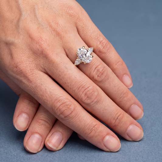14 KT Yellow Gold Oval Cut Diamond Cluster Engagement Ring with Pear Accents - worn close-up