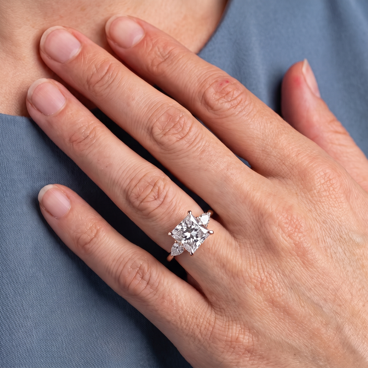 18 KT Rose Gold Princess Cut Diamond Cluster Engagement Ring with Pear Accents - worn close-up