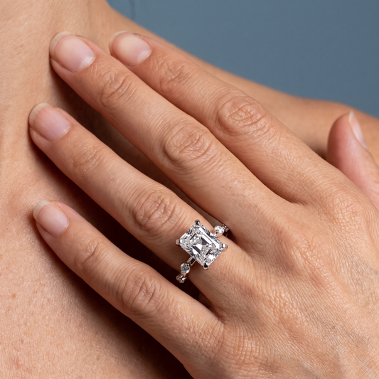 14 KT White Gold Radiant Cut Diamond Solitaire Ring with Floating Diamond Accents - worn close-up