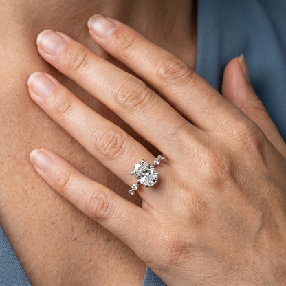 14 KT White Gold Oval Cut Diamond Solitaire Ring with Floating Diamond Accents - worn close-up