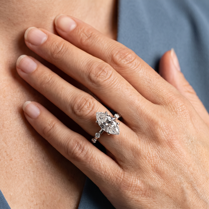 Platinum Marquise Cut Diamond Solitaire Ring with Floating Diamond Accents - worn close-up