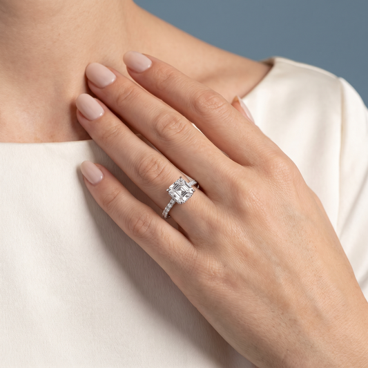 18 KT White Gold Asscher Cut Diamond Hidden Halo Ring with Pave Band - worn close-up