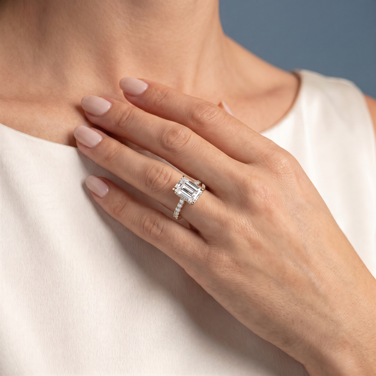 14 KT Yellow Gold Emerald Cut Diamond Solitaire Ring with Pave Eternity Band - worn close-up