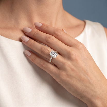 18 KT Yellow Gold Emerald Cut Diamond Solitaire Ring with Pave Eternity Band - worn close-up