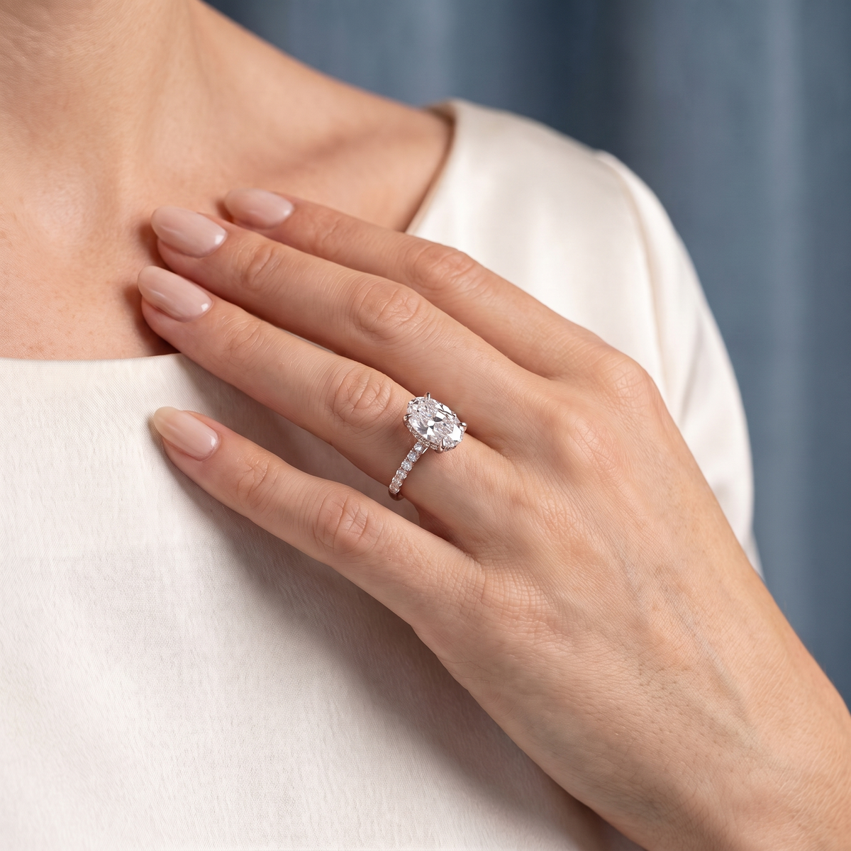 18 KT Rose Gold Oval Cut Diamond Solitaire Ring with Pave Eternity Band - worn close-up