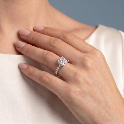 14 KT Rose Gold Princess Cut Diamond Solitaire Ring with Hidden Halo and Pave Band - worn close-up