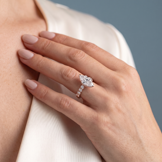 18 KT Rose Gold Marquise Cut Diamond Solitaire Ring with Hidden Halo and Pave Band - worn close-up