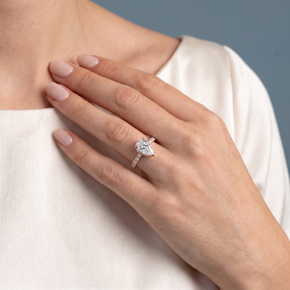 18 KT Rose Gold Pear Cut Diamond Hidden Halo Ring with Pave Band - worn close-up