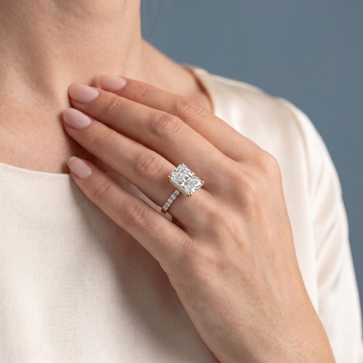 14 KT Yellow Gold Radiant Cut Diamond Hidden Halo Ring with Pave Band - worn close-up