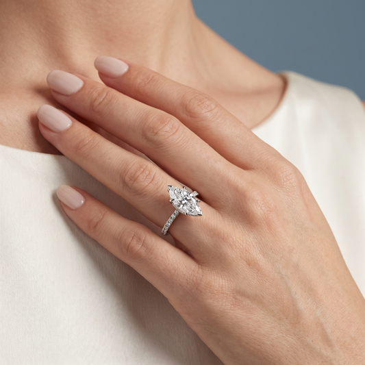 18 KT White Gold Marquise Cut Diamond Solitaire Ring with Hidden Halo and French Pave Band - worn close-up