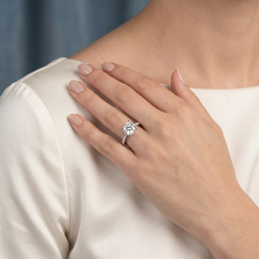 Platinum Cushion Cut Diamond Solitaire Ring with Hidden Halo and French Pave Band - worn close-up