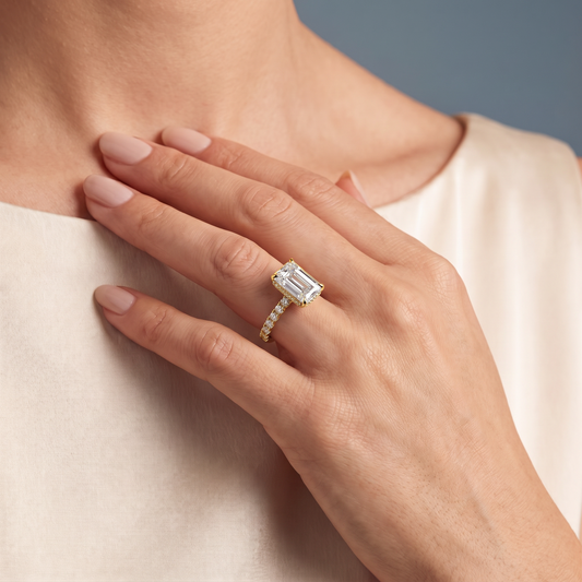 14 KT Yellow Gold Emerald Cut Diamond Solitaire Ring with Hidden Halo and French Pave Band - worn close-up