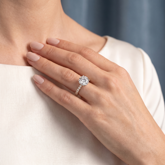 18 KT Rose Gold Round Cut Diamond Solitaire Ring with Hidden Halo and French Pave Band - worn close-up